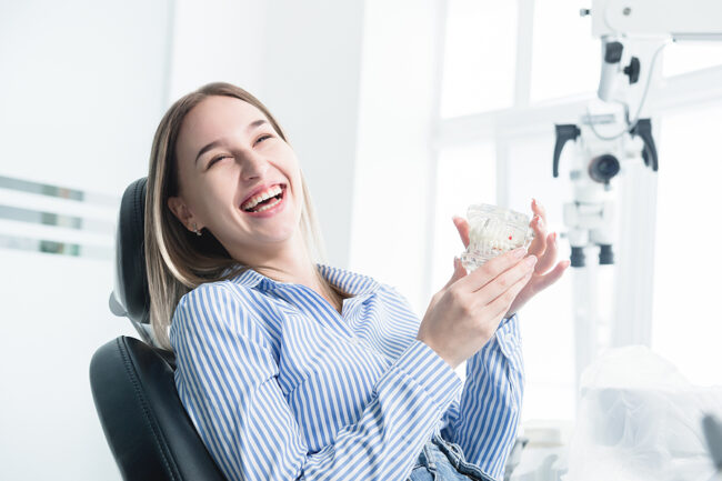 Portrait Of A Happy Attractive Girl In A Dental Chair. Laughing