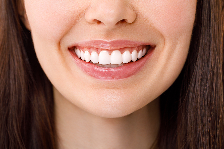 A Beautiful Woman Is Smiling. A Smile With White Teeth. Close Up